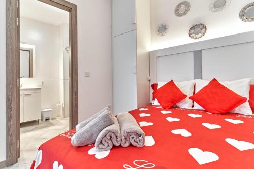 a bedroom with a red bed with red pillows at Nerja Boutique B3 Sweet Corner in Nerja