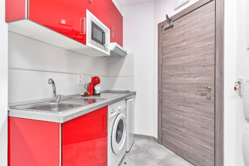 a kitchen with a sink and a washing machine at Nerja Boutique B3 Sweet Corner in Nerja