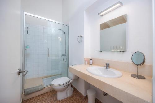 a bathroom with a toilet and a sink and a shower at Can Claret in Felanitx