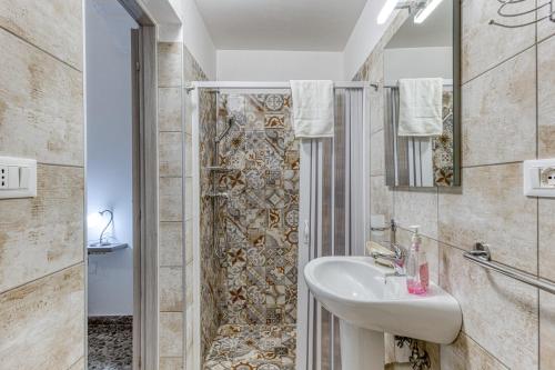 a bathroom with a sink and a shower at Dimore degli innamorati in Presicce