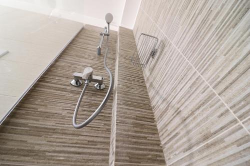 a shower in a bathroom with a wooden floor at Holiday home Galatea a Otranto in Otranto