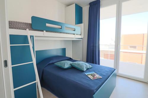 a bedroom with a bunk bed with a ladder at Holiday home Galatea a Otranto in Otranto