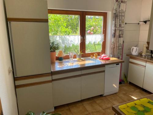 a kitchen with a counter top and a window at Haus Sonnengarten in Seelbach