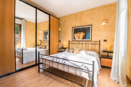 a bedroom with a bed and a large window at Appartamento vista lago in Sulzano