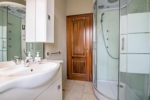 a bathroom with a sink and a shower at Appartamento vista lago in Sulzano