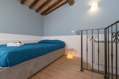 a bedroom with a bed with blue sheets at Lecasedicatia in Villamagna