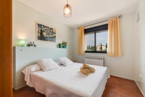 a bedroom with a bed with a teddy bear on it at Sueños de Guara Casa rural in Casbas de Huesca