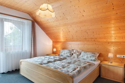 a bedroom with a bed with a wooden ceiling at Haus Marianne Dörflinger in Schluchsee