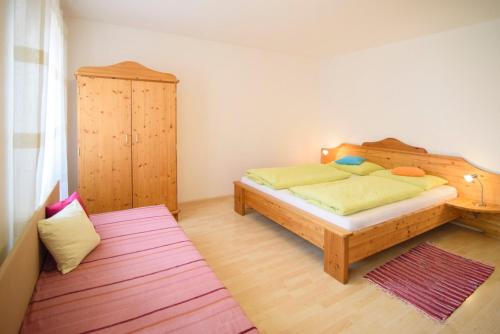 a bedroom with a bed and a cabinet in it at Peter Paul Terrasseapp Burgenblick in Appiano sulla Strada del Vino