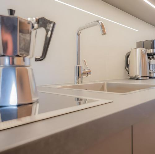 a kitchen counter with two sinks and a mirror at Peintnerhof Percha in Perca