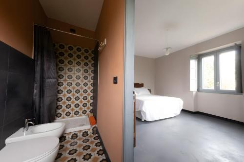 a bathroom with a shower and a toilet and a sink at Beb La Patataia Home in Bormida