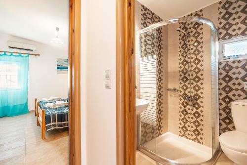a bathroom with a shower and a toilet at Beach Pearl in Lachania