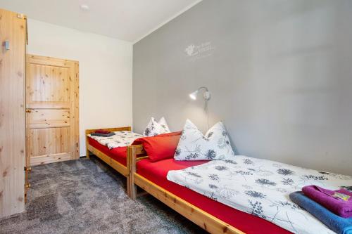 a bedroom with a bed with a red couch at Ferienhaus Dorfidyll in Bugewitz