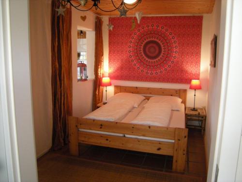 a bedroom with a bed with a red wall at Rhön-Antik in Dipperz