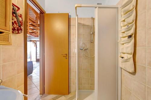 a shower with a glass door in a bathroom at Grace house holiday in San Fedele Intelvi