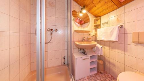 a small bathroom with a sink and a shower at Ferienwohnungen Weiß in Mittenwald