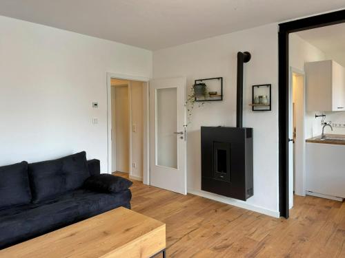 a living room with a couch and a tv at Ferienhaus Ahaus in Ahaus