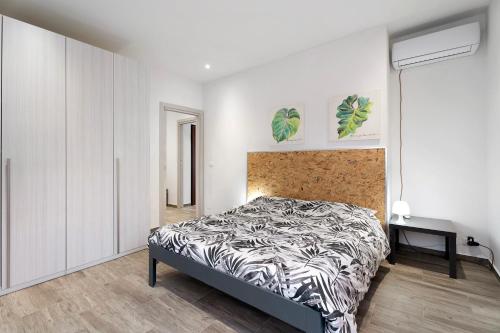 a bedroom with a bed in a white room at Sweet Home Apartments Peperoncino in Arona