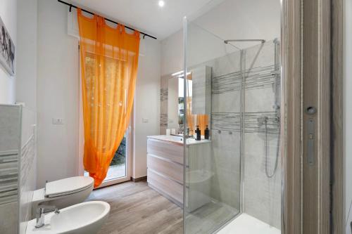 a bathroom with a shower and a toilet and a sink at Sweet Home Apartments Peperoncino in Arona