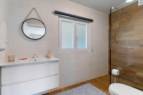 a bathroom with a sink and a mirror at Casa do Canudo in Marinha Grande