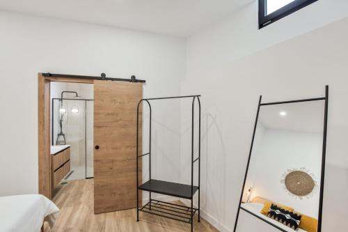a bedroom with a mirror and a vanity with a mirrorstand at Finca Los Tilos Moya in Moya