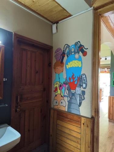 a bathroom with a painting on the wall at Hikers & Bikers in Haripūr