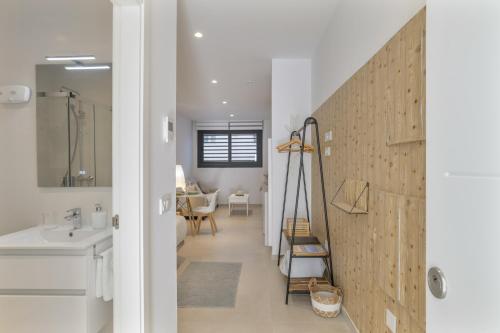 a bathroom with a white sink and a staircase at Apartamento Tarifa Dream B 08 in Tarifa