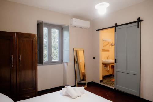 a bedroom with a mirror and a bathroom with a sink at Beb La Patataia Home in Bormida