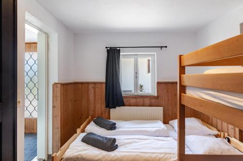 two bunk beds in a room with a window at Feichtenhäusl app 1 in Westendorf