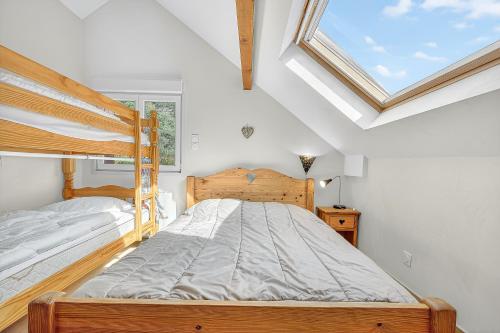 a bedroom with a wooden bed and a window at Chalet Ma Bonne Etoile in Les Prats