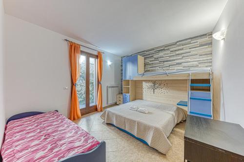 a bedroom with a bunk bed and a large window at Casa Castro Vista Grotta in Castro di Lecce