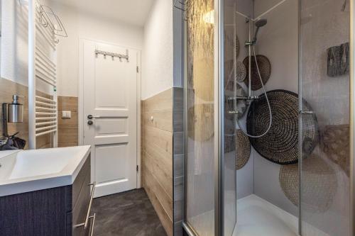 a bathroom with a shower and a sink at Cosy Apartment In Soltau in Soltau