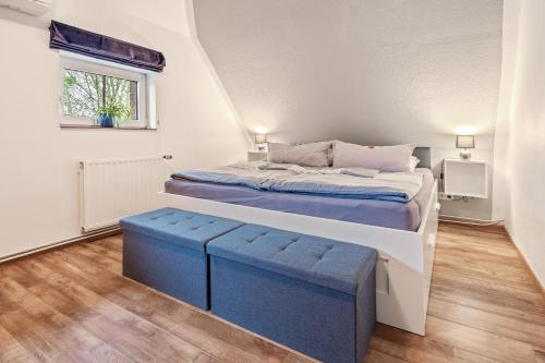 a small bedroom with a bed and a window at Cosy Apartment In Soltau in Soltau