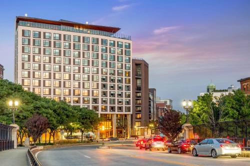 a large building with cars parked on a city street at Cambria Hotel Boston Downtown - Seaport in Boston