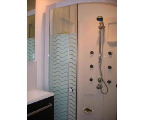 a bathroom with a shower with a glass door at Chalet - Les 3 vallées in La Combe