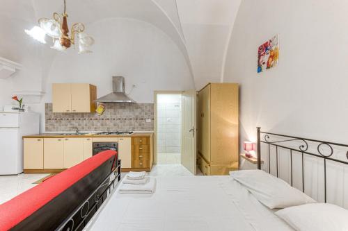 a kitchen with a large bed in a room at Dimore degli innamorati in Presicce