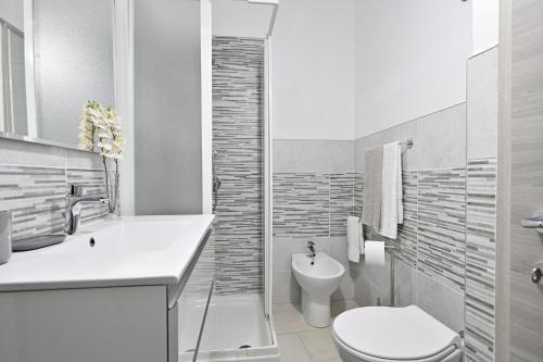 a white bathroom with a toilet and a sink at Jerzu Centro in Jerzu