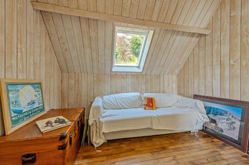 a bedroom with a bed in a room with a window at Évasion marine face à la mer in Plouézocʼh