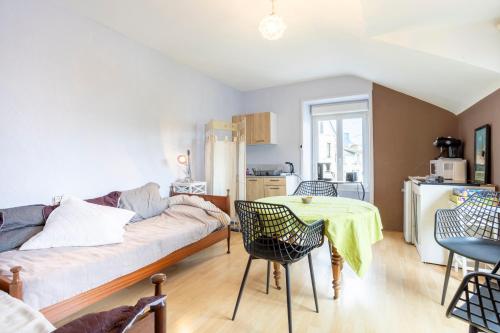 a living room with a couch and a table at L'Eclose Chambre Kergoz in Le Guilvinec