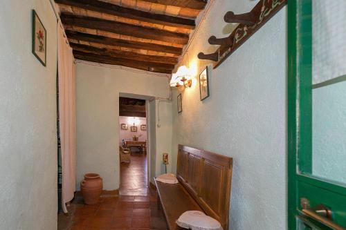 a hallway of a house with a wooden ceiling at Casina nel Borgo Antico in Bibbona