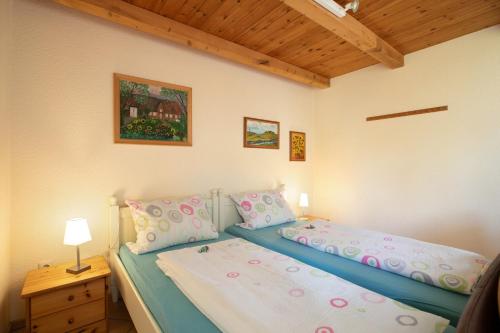 a bedroom with a bed and a wooden ceiling at Apartment Eulenhof 2 in Bordelum