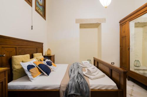 a bedroom with a bed with pillows on it at Dimora Cariddi Otranto in Otranto