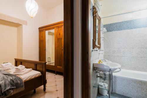a bathroom with a sink and a bath tub at Dimora Cariddi Otranto in Otranto