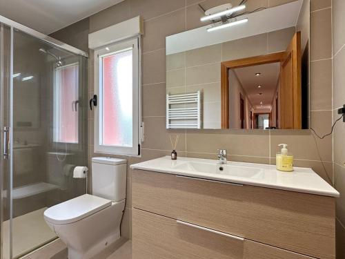 a bathroom with a sink and a toilet and a mirror at Villa Mila in Tera