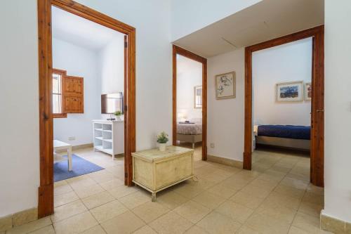 a room with a bedroom with a bed and two mirrors at Maca Green, Adosado Centro Campanet in Campanet