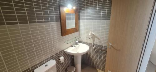 a bathroom with a sink and a mirror at Apartamento La Palma Corralejo in Corralejo