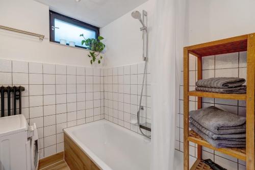 a bathroom with a bath tub and a sink at Ferienwohnung Am Lehen Schiltach in Schiltach