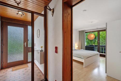 a bedroom with a bed and a glass door at Ferienwohnung Am Lehen Schiltach in Schiltach