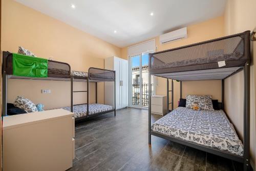 a room with three bunk beds and a hallway at Casa Lluma in Aldover