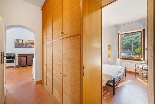a bedroom with a bed and a large wooden closet at Luca Via Gavazzo 18 in Bonassola